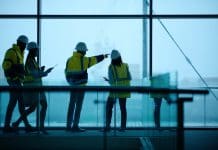 How AI is set to transform project management in construction Construction, engineering and teamwork with building project, people and cooperation with brainstorming. Group, architects and industrial with support and modern office with safety and collaboration, representing construction project management