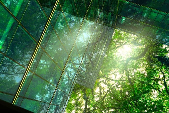 Sustainble green building. Eco-friendly building. Sustainable glass office building with tree for reducing carbon dioxide. Office with green environment. Corporate building reduce CO2. Safety glass. Sustainable green building. Eco-friendly building. Sustainable glass office building with tree for reducing carbon dioxide. Office with green environment. Corporate building reduce CO2. Safety glass, all representing net zero buildings