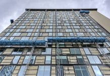 Beyond the backlog: Why the UK’s cladding remediation is a systems failure View of building remedial work being carried out to a building at Salford Quays, Manchester, UK. There are no people in the photograph, represents cladding remediation