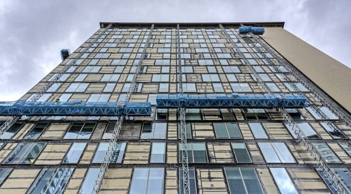 View of building remedial work being carried out to a building at Salford Quays, Manchester, UK. There are no people in the photograph, represents cladding remediation