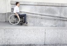 How accessibility, clearance and data validation checks unlock project wins with BIM Man in a wheelchair using accessible ramp, representing the need for data validation checks