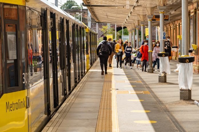 Light rail Metrolink tram in the city center of Manchester, UK Manchester, United Kingdom - 2 August, 2020 : Light rail Metrolink tram in the city center of Manchester, UK, one of the areas that will benefit under the proposed regional transport investment funding