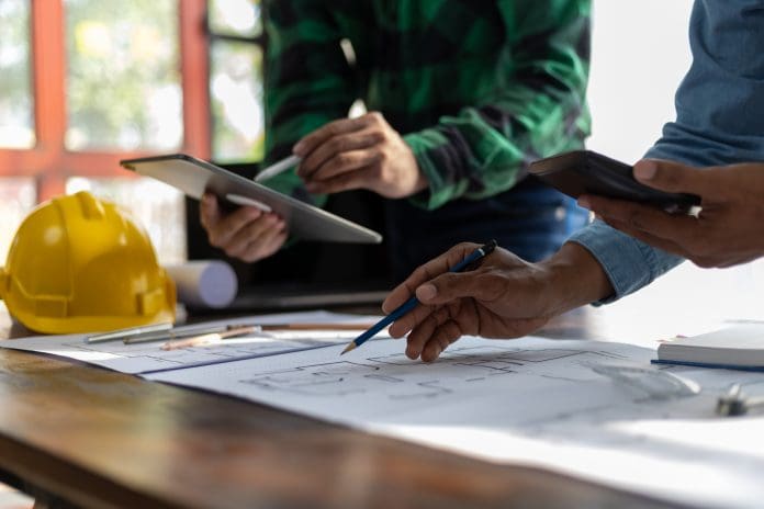 Construction and structure concept planning of Engineer or architect meeting for project working with partner and engineering on model building and blueprint in working site. Construction and structure concept planning of Engineer or architect meeting for project working with partner and engineering on model building and blueprint in working site, representing Missed deadlines in architecture