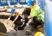 NUAR goes public as it moves into next phase of development Two workers in hard hats and hi viz clothing working on underground cables