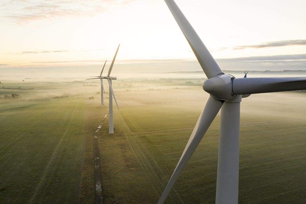 Aerial view of three wind turbines in the early morning fog at sunrise in the English countryside Until 29 July, projects are encouraged to submit evidence to the Connections Reform process at National Energy System Operator (NESO)