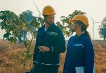 Public sector to miss 2035 decarbonisation targets, new report claims Two engineers walking and discuss operational aspects of wind turbines in renewable energy farm. Green ecological power generation wind sustainable energy concept, representing decarbonisation targets