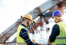 Transforming AECO project delivery: How Newforma is solving the industry’s toughest challenges Engineers and architects on construction site, with blueprints and digital tablet with software for better calculations. Image taken with Nikon D800 and developed from RAW in XXXL size.