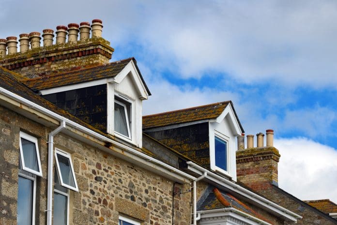 Chimneys and dormer windows, Marazion, Cornwall, England Marazion, Cornwall, England, UK: clay chimney pots and dormer windows on rooftops - Victorian row of terrace housing.