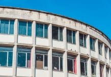 Construction industry leads company insolvencies in UK Close-up of a curved, decaying building in liverpool, highlighting its broken windows and state of disrepair, representing construction insolvencies