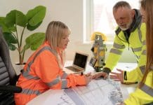 Apprenticeship age restrictions could cost planning profession 200 planners a year, RPTI warns Engineering professionals collaborate on construction plans in bright office wearing safety hi-viz gear, representing those affected by apprentice age restrictions