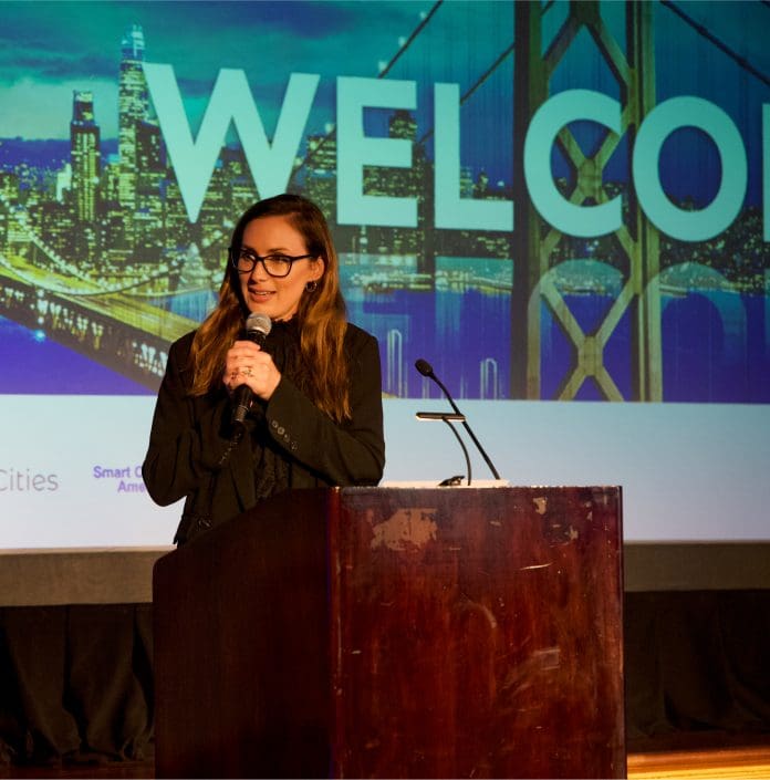 Audrey Lynch, director of research at BuiltWorlds, delivering a talk on stage