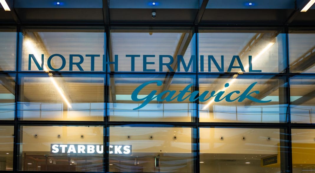 Signage above the main entrance to departures at North Terminal, Gatwick Airport, London, UK, representing the Gatwick expansion plans