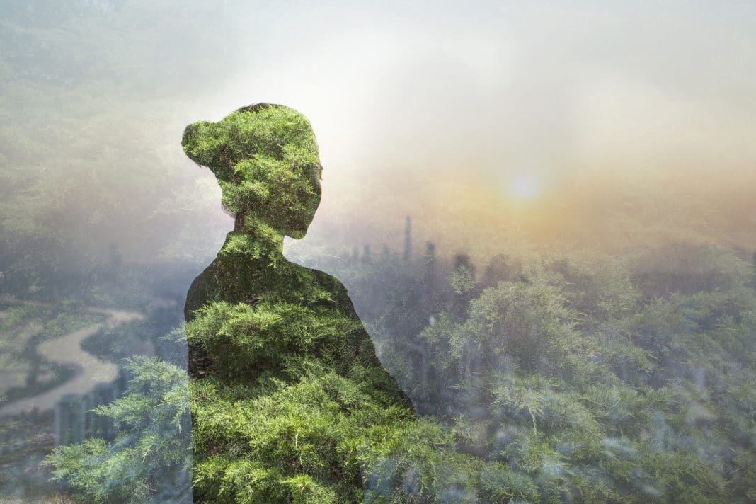Person standing in contemplation in urban city with nature trees composite, Shenzhen, China, representing the role of planning in supporting mental health