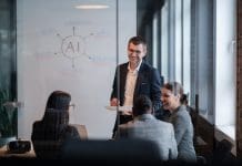 AI Execution Gap growing in construction- but huge leap ahead projected Diverse business team in a modern office during a meeting, discussing artificial intelligence strategy. Concept of AI innovation, teamwork, leadership, corporate planning, professional collaboration, reperesenting the AI execution gap