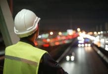 Outlook gloomy in latest Glenigan index report Asian man engineer working at night standing deep in thought, representing the latest glenigan outlook