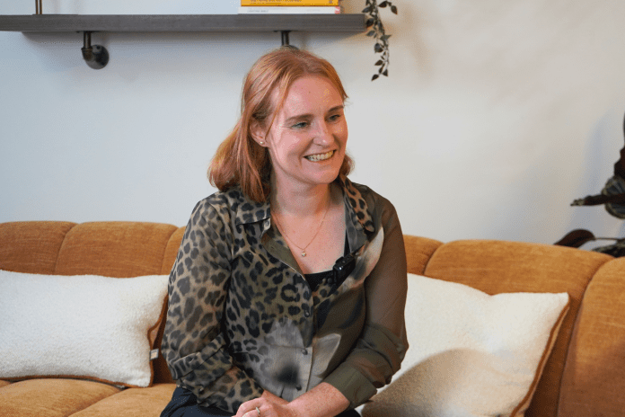 Denise Tuffy of the Smart Off-site Association sat on a sofa looking to her left in conversation