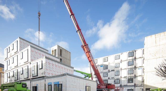 A crane lifting modular building units into place at the Desborough Road development by Premier Modular, representing fire safety in modular buildings
