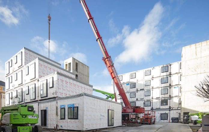 A crane lifting modular building units into place at the Desborough Road development by Premier Modular, representing fire safety in modular buildings