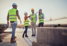 Projects like mine, doing things I can do omparing with the blueprints, a team of experts is evaluating the realization on the construction site. For their own safety, all members have yellow vests and hard hats.
