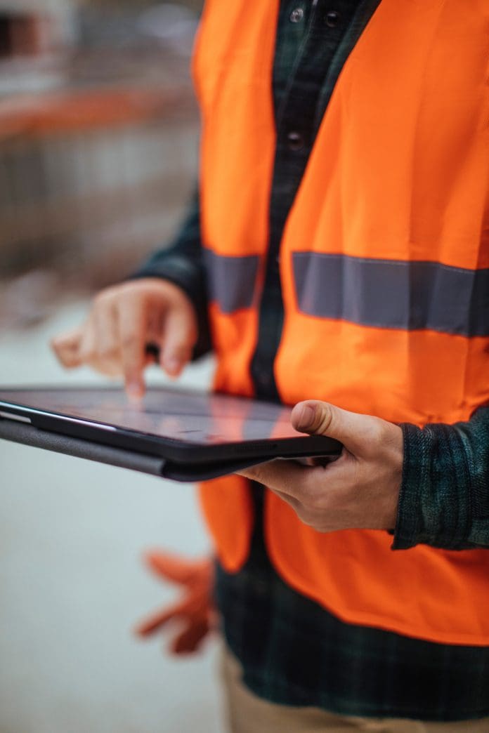 Resilient delivery starts with better Project Information Management Unrecognizable construction worker using a digital tablet while working at a building site, representing Project Information Management
