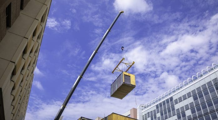 Modular wood commercial building prefabricated assembled with crane, representing Ireland's offsite manufacturing
