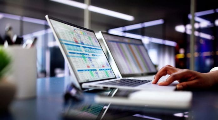 Calculating electronic medical accounts and codes in a black office using a spreadsheet on a computer screen.