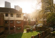 UK council climate action not improving fast enough for 2030 targets, report finds An apartment building area in London at sunset, representing UK council climate action