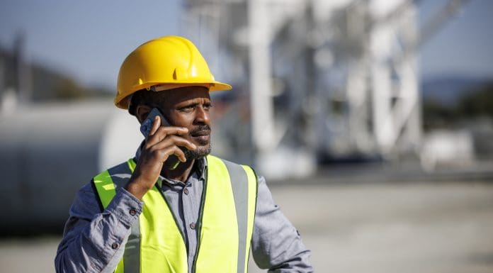Project Manager Discussing Work Plans Over the Phone at a Construction Site, representing the Assent collapse