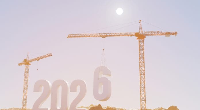 Prepare to welcome the new year 2026. Large construction site, construction cranes set numbers 2026. Construction team sets numbers for New Year 2026, representing the latest glenigan forecast