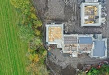 Building with nature in mind: Why is it needed House development construction site in progress aerial view UK, representing building with nature