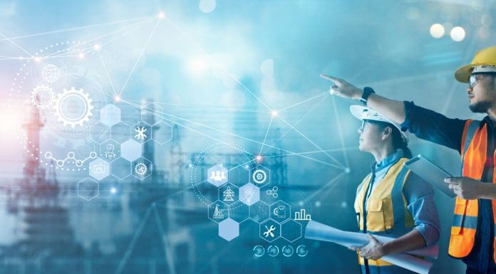 Male and female industrial engineers using tablet computer and blueprints checking and analysis data of power plant station project on network background, representing Construction industry outlook 2026