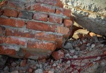 Construction firm fined after worker crushed Close-up of the destroyed building. Fragments of red brick and reinforced concrete floors.