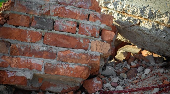Close-up of the destroyed building. Fragments of red brick and reinforced concrete floors.