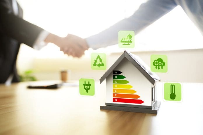 Energy-saving homes, energy efficiency concepts, eco-friendly home improvements, cost savings, low-energy eco-friendly homes, green handshake. Energy-saving homes, energy efficiency concepts, eco-friendly home improvements, cost savings, low-energy eco-friendly homes, green handshake.