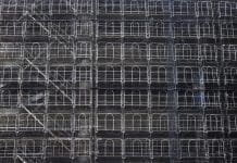 Making scaffolding more sustainable Abstract background of construction site with scaffolding the building cover.