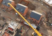 New Single Construction Regulator Prospectus published Aerial view of yellow mobile crane lifting materials on construction site, representing the new Single Construction Regulator prospectus