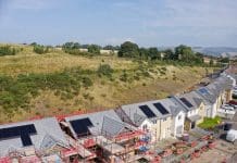 Industry reacts to the new National Planning Policy Framework draft revision Solar panels installed on home roofs at new housing development UK, representing the National Planning Policy Framework draft revisions