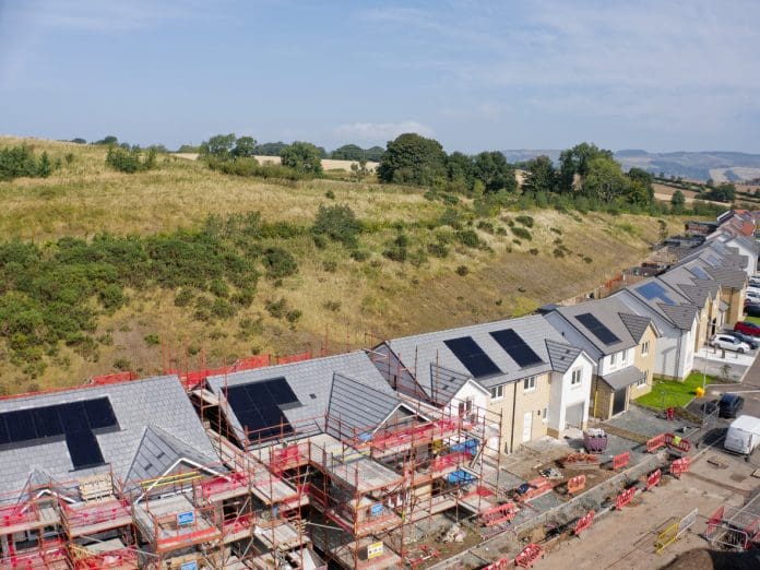 Industry reacts to the new National Planning Policy Framework draft revision Solar panels installed on home roofs at new housing development UK, representing the National Planning Policy Framework draft revisions
