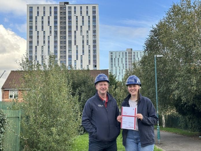 Pick Everard achieves fire safety assurance on Salford high-rise buildings Pick Everard employees standing outside one of the buildings with the fire safety assurance certificate