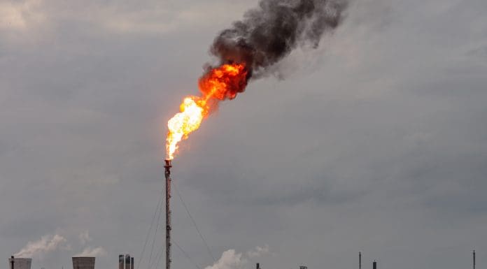 Environmental damage: A large flame and dark smoke rising from a flare stack at Grangemouth oil refinery and petrochemical plant in Scotland.