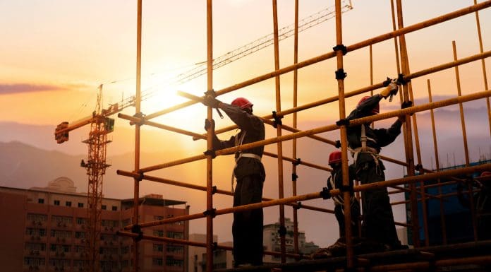 Group of construction workers working on scaffolding