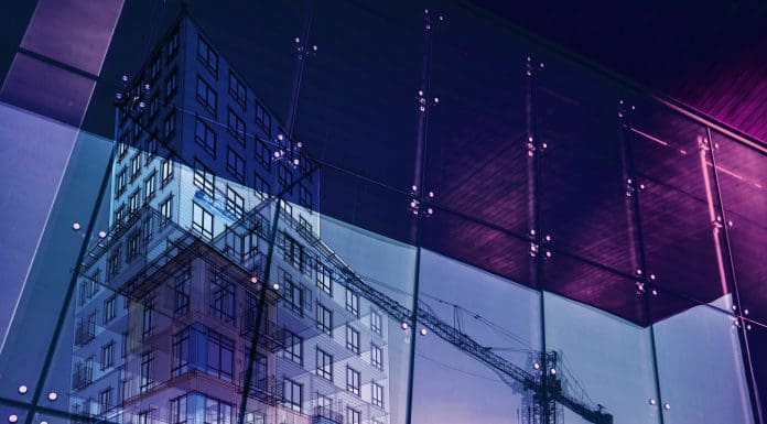 Construction crane and a new high rise building reflected into a newly built office building. New offices are being built to satisfy the growing demand (note to inspector: i am the author of the project) Representing the future of BIM