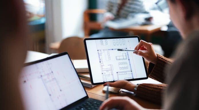 A group of individuals collaborate on a digital architectural blueprint on tablets, illustrating teamwork and learning in a casual, modern educational setting. Ramboll's Mark Furlonger provides his perspective on the Government’s proposed overhaul of the National Planning Policy Framework