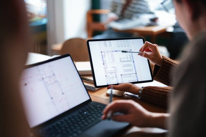 A group of individuals collaborate on a digital architectural blueprint on tablets, illustrating teamwork and learning in a casual, modern educational setting. Ramboll's Mark Furlonger provides his perspective on the Government’s proposed overhaul of the National Planning Policy Framework