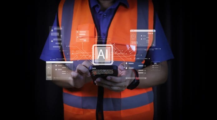 Industrial technician using mobile app to query data from AI chatbot. Smart factory worker consulting artificial intelligence for problem solving. Future construction communication. AI in construction is prophesised to bring productivity gains- but arguably the greatest transformation could lie in how risk is identified