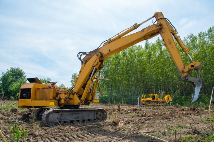 Mechanical Site Preparation for Forestry. Mechanical Site Preparation for Forestry. Excavator and bulldozer clearing forest land.