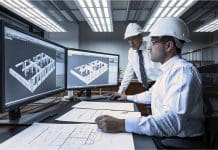 Business cyber resilience starts with understanding your data Two men in white shirts and hard hats look at two computer screens displaying 3D virtual models of building designs
