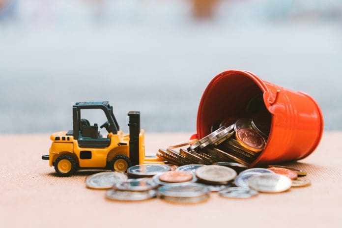 Closeup stack coins with construction vehicle Closeup stack coins with construction vehicle using as business, industrial and financial concept