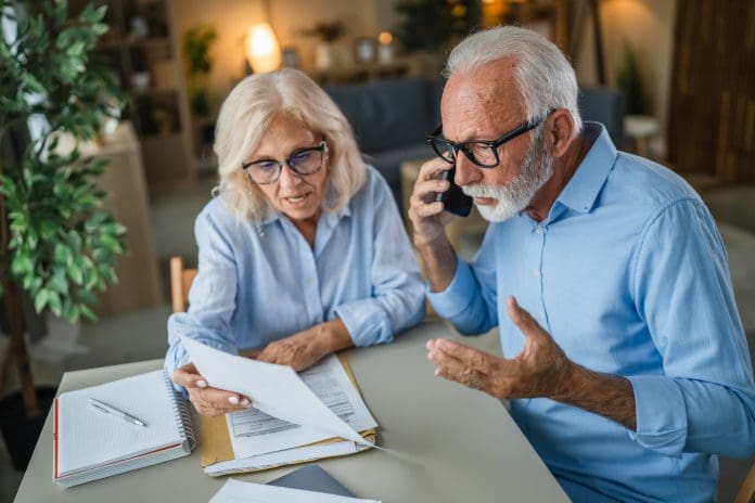 Senior couple dealing with financial problems and bureaucracy Northern Irish cowboy builders are costing homeowners nearly £500 on average