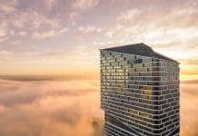 How digital construction is ending demolition as the default An aerial shot of Quay Quarter in Sydney emerging above the clouds